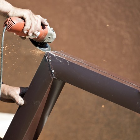 San Ramon CA Rain Gutter Installation and Repair Contractor cutting a metal rain gutter during an installation in San Ramon CA