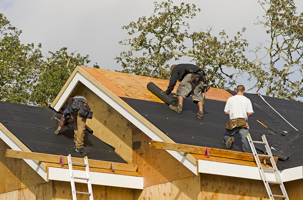roofing-078 Three contractors installing black roofing underlayment on a multi-pitched residential roof in Alamo, CA.