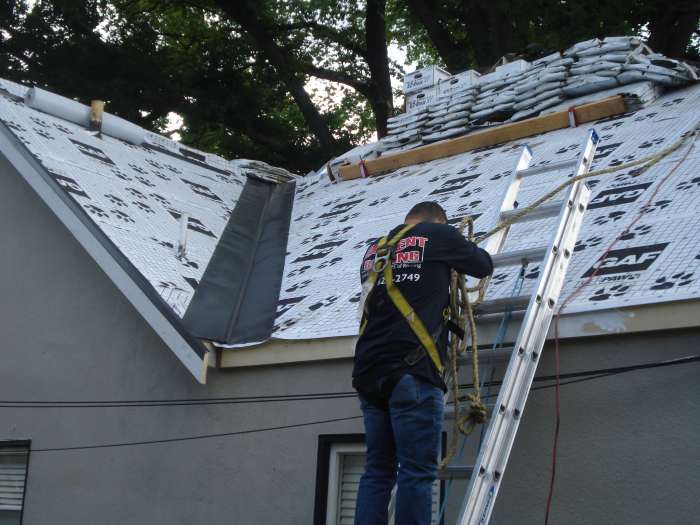 Residential Roof Underlayment & Installation in Antioch Roofing contractor wearing safety harness climbing a ladder to install underlayment on a residential roof in Antioch