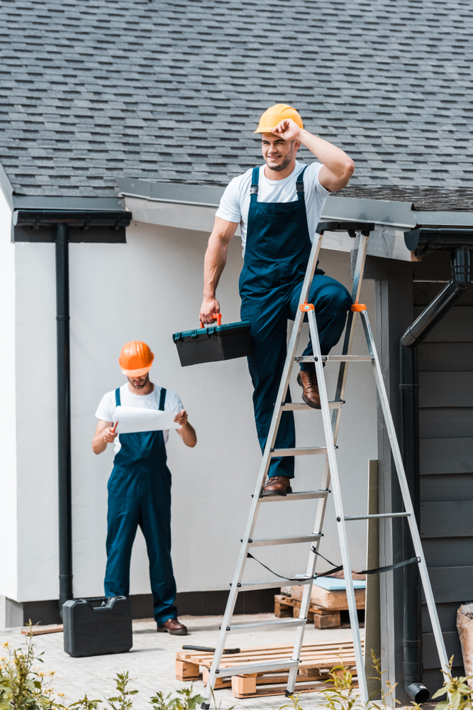 Selective,Focus,Of,Builder,Touching,Helmet,And,Standing,With,Toolbox
